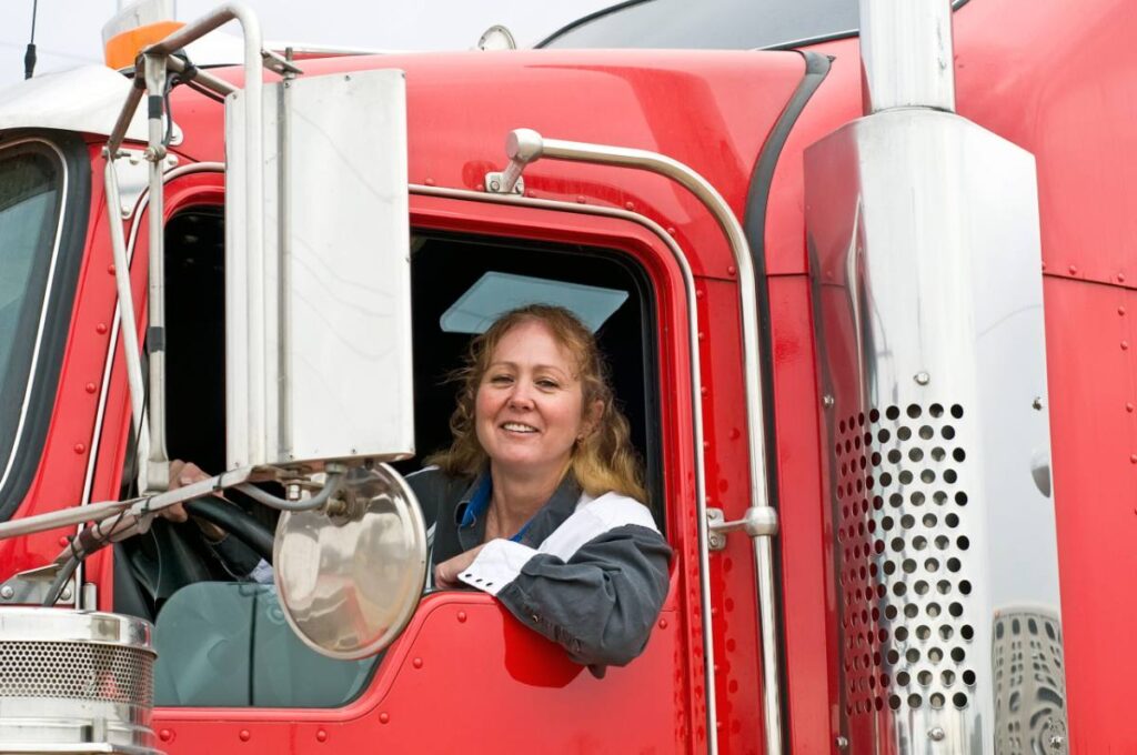 Driver at the window of a red commercial truck