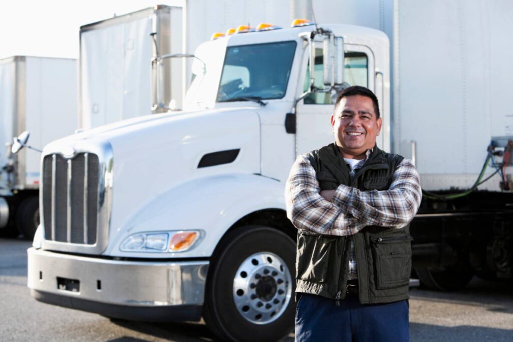 Owner-operator standing in front of his truck