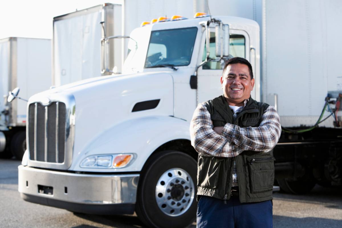 Owner-operator standing in front of his truck